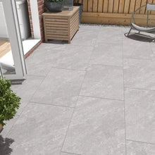 Outdoor porcelain patio tiles on a UK terrace with fenced seating area