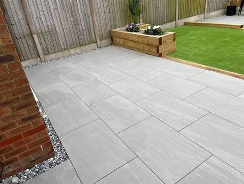 Outdoor porcelain patio tiles laid in a modern garden.
